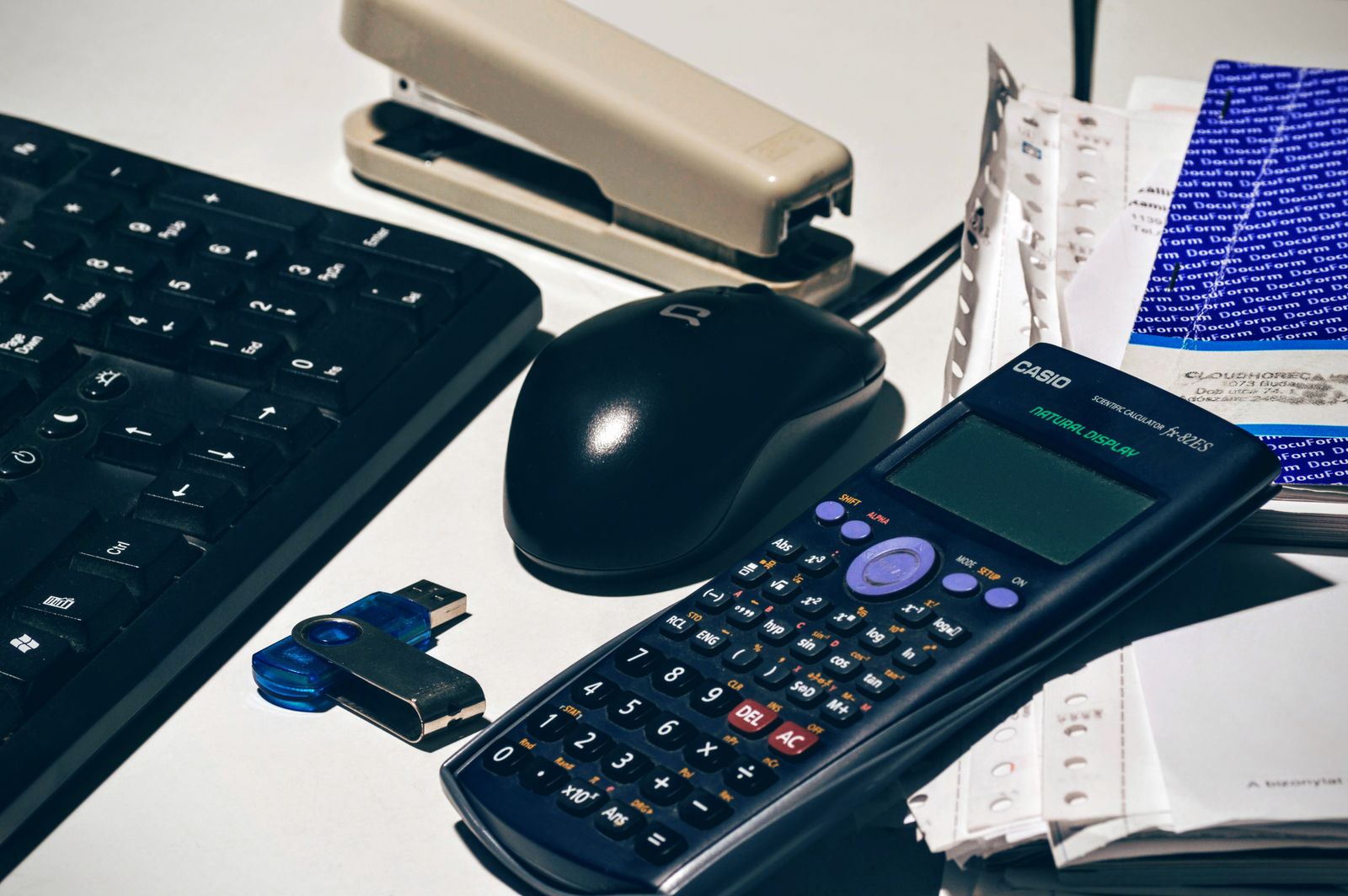 Desk with calculator and receipts used for bookkeeping